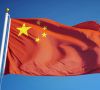 China flag waving against clean blue sky, close up, isolated wit
